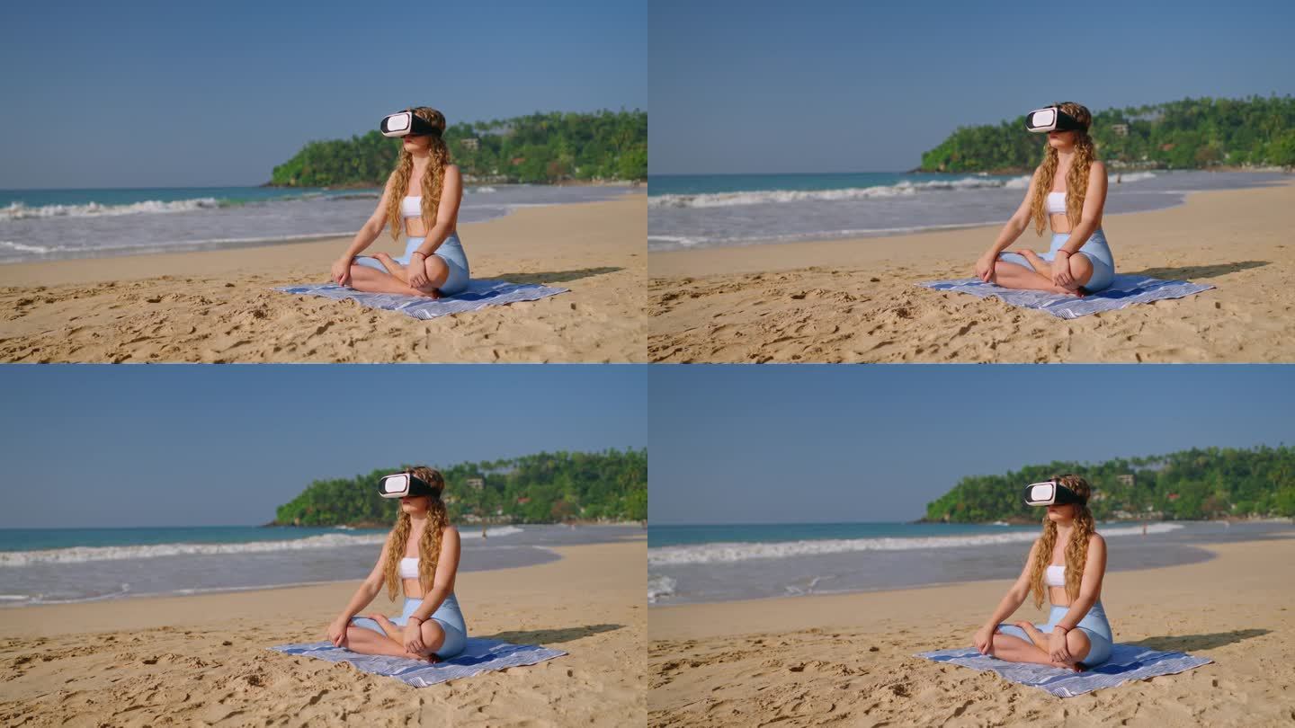 戴着VR头显的女人盘腿坐在沙滩上，体验虚拟冥想，海浪抚摸海岸，沉浸式放松，日出倒映水面，科技满足宁静