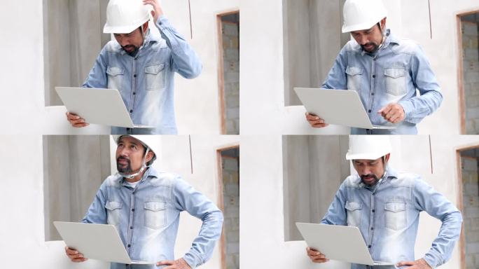 成熟的印度建筑师检查员男性会在工地上仔细查看笔记本电脑上的数字蓝图或在工作场所查找信息，专业的工程领