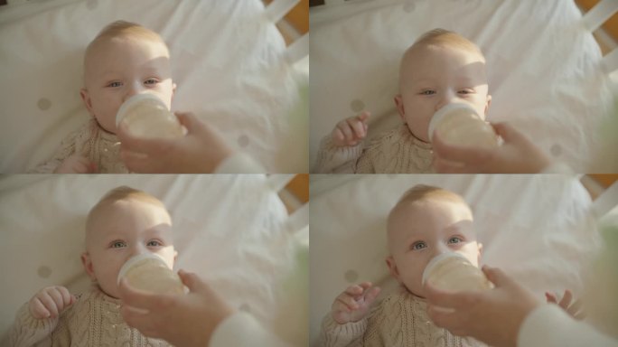 SLO MO滋养的爱:婴儿从奶瓶里吃奶时母亲温柔的关怀