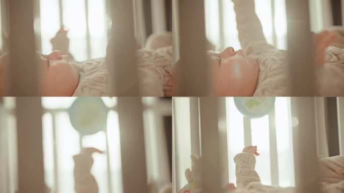 阳光下的探索:婴儿男孩在摇篮里好奇地寻找快乐，被晨光拥抱