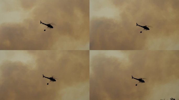 消防直升机在野火上洒水