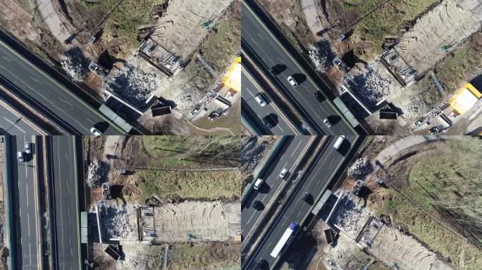 无人机从高速公路旁的建筑工地拍摄到的废墟，那里有汽车和卡车在行驶。