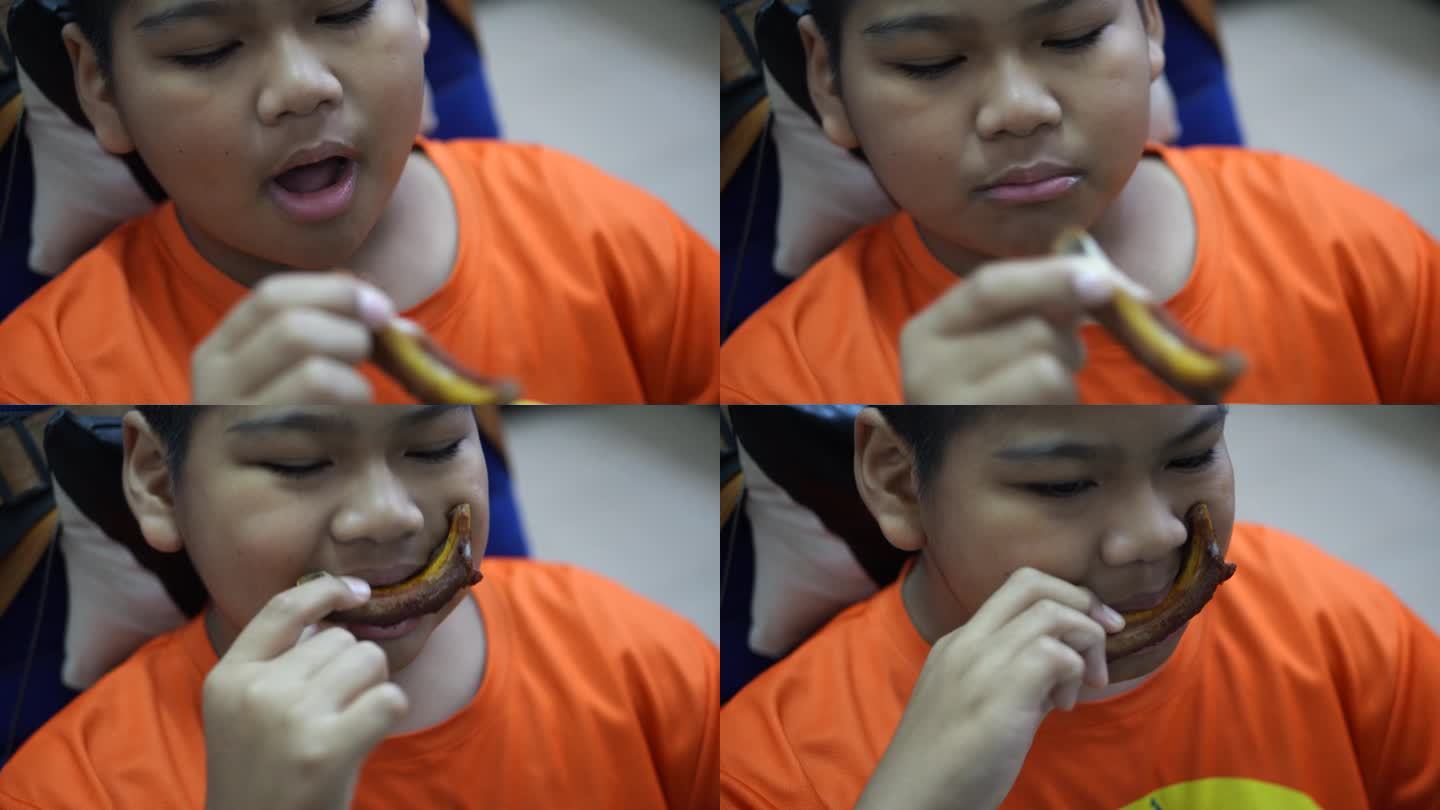 一个男孩吃炸排骨的特写