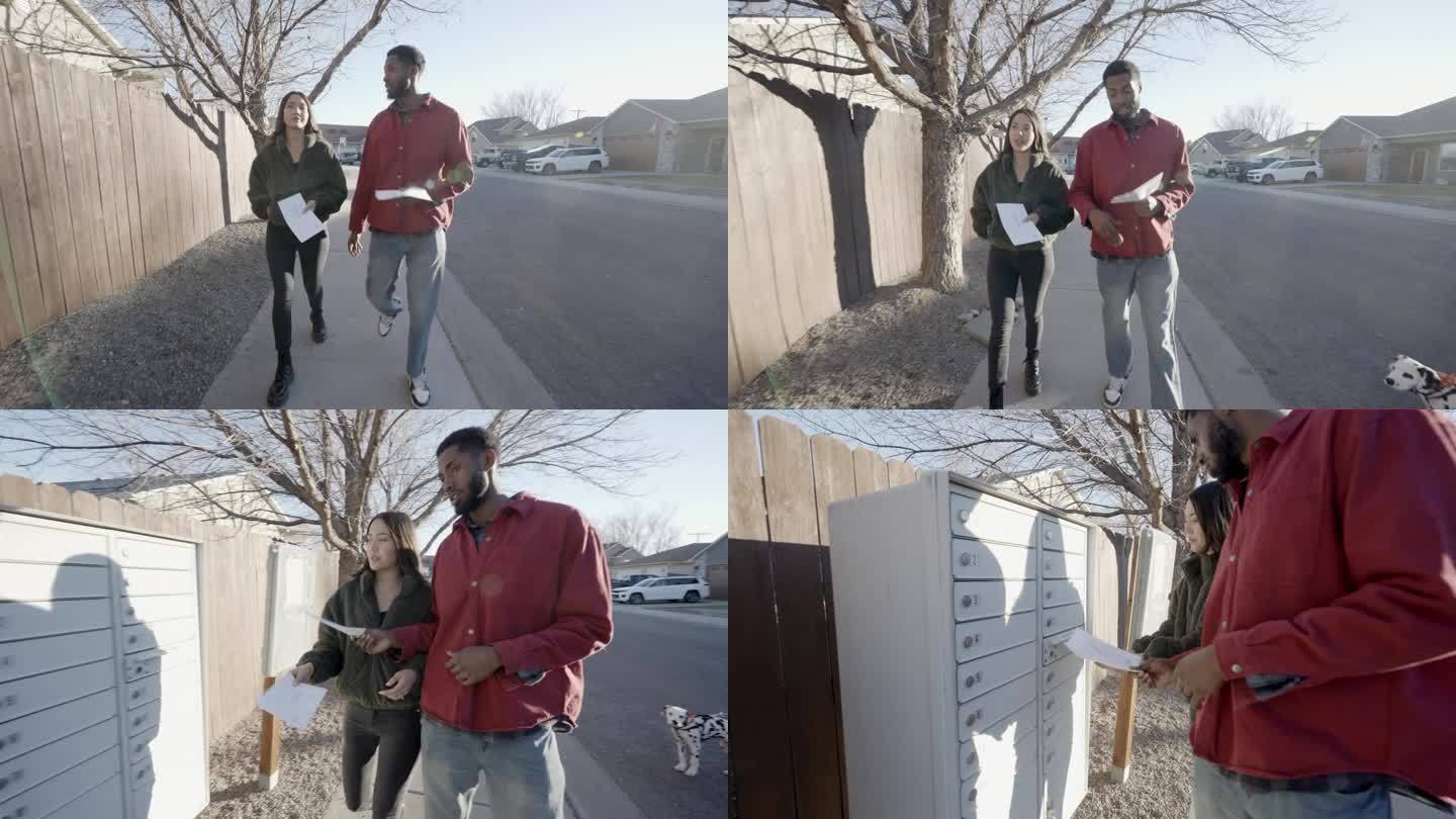 20多岁的年轻混血夫妇，西班牙裔和非裔美国人走上前，把邮寄选票投进了附近的邮箱