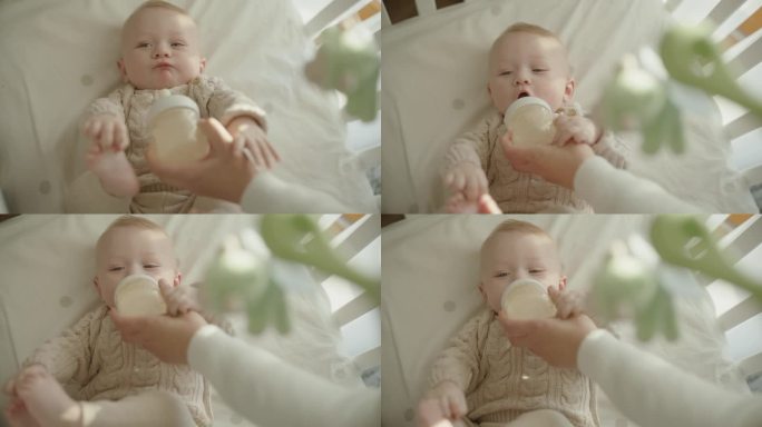 SLO MO滋养的爱:婴儿从奶瓶里吃奶时母亲温柔的关怀