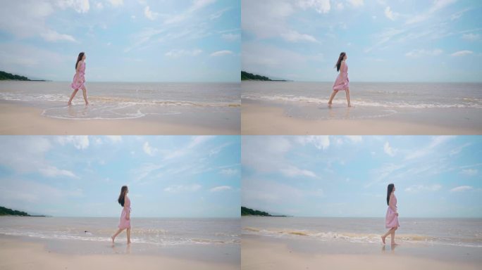 美女在海边漫步游玩遥望远方海水冲刷白沙滩