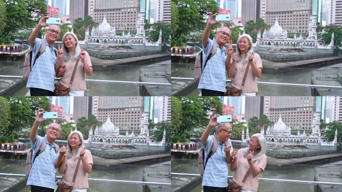 两名亚洲老人在生命之河的木栈道上用智能手机自拍