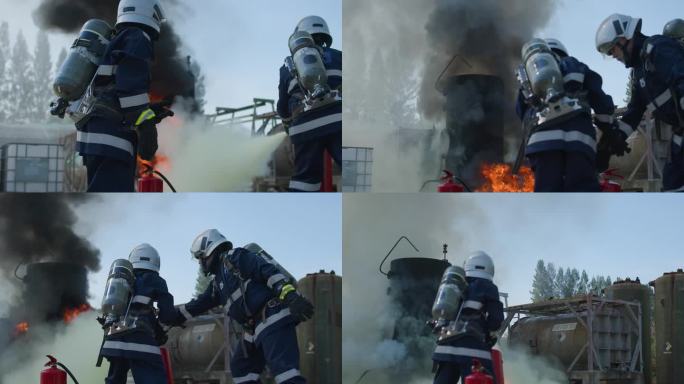 消防员在训练中用消防水带向火场喷射高压水，消防员在危险情况下穿着消防服以确保安全