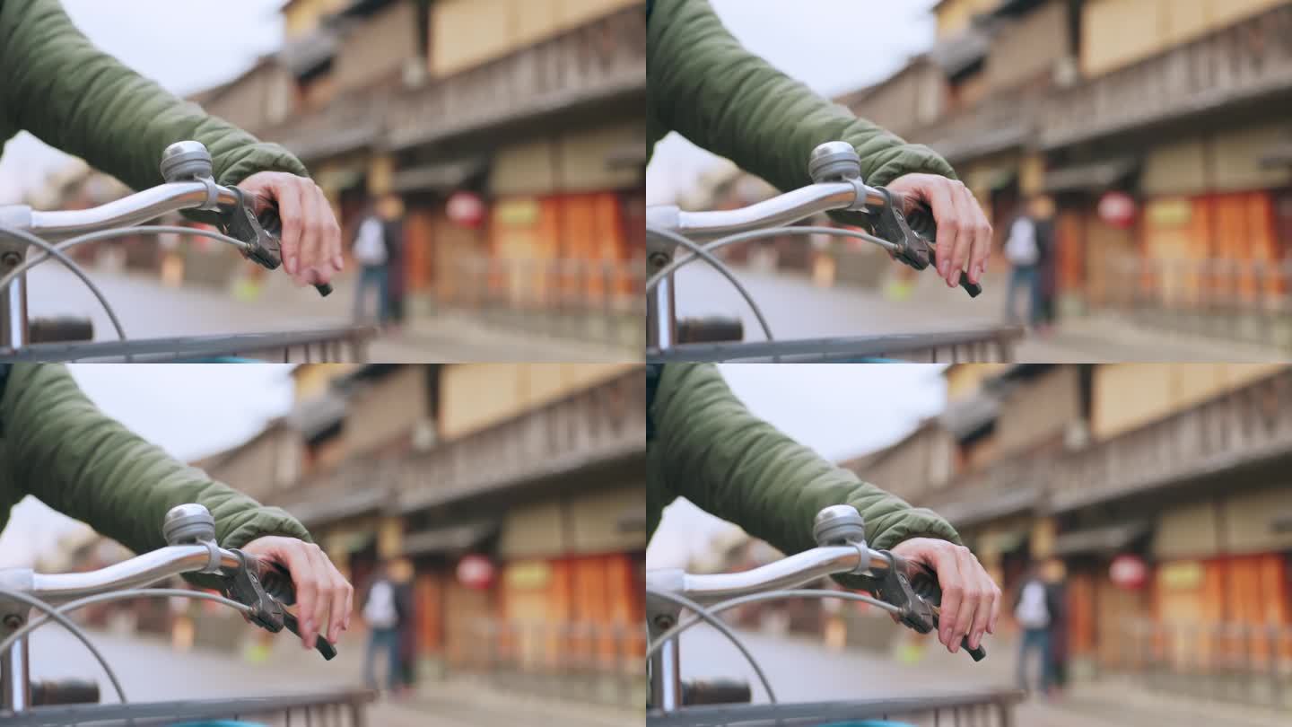 城市道路上积极骑行者的手、自行车及刹车把手，以保持健康。特写，按车把和骑自行车的人来控制或检查在日本