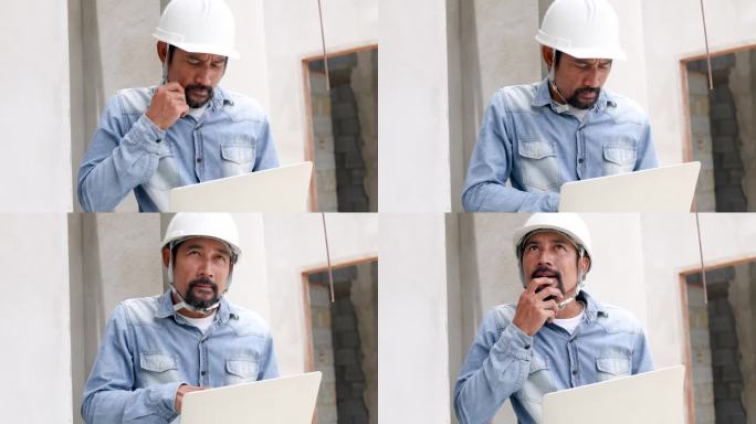 成熟的印度建筑师检查员男性会在工地上仔细查看笔记本电脑上的数字蓝图或在工作场所查找信息，专业的工程领