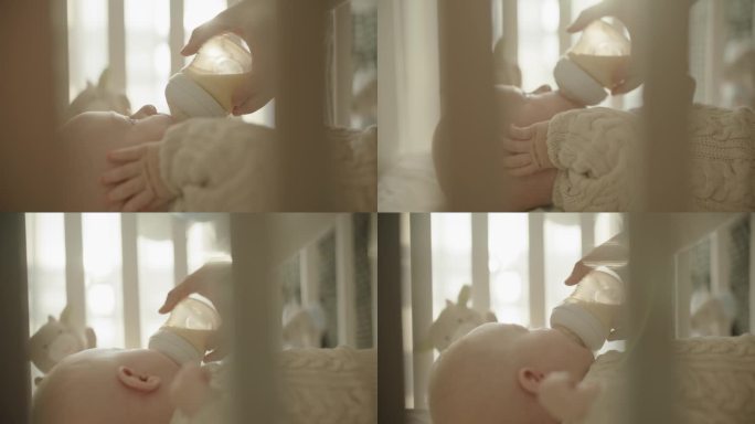 SLO MO滋养的爱:婴儿在阳光的怀抱中从奶瓶里喂奶时母亲的温柔关怀