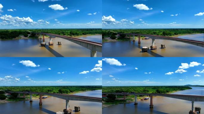 令人惊叹的无人机拍摄巴拉圭河和桥梁的视频，展示了晴朗蓝天下广阔的潘塔纳尔湿地。正在维修的桥梁增添了独