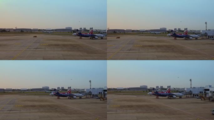 夕阳下机场两架客机同时起飞比翼双飞