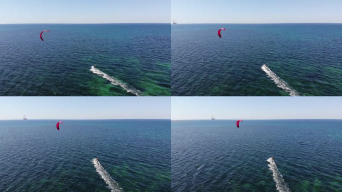 在一个阳光明媚的日子里，年轻的女运动员在大海上玩风筝冲浪
