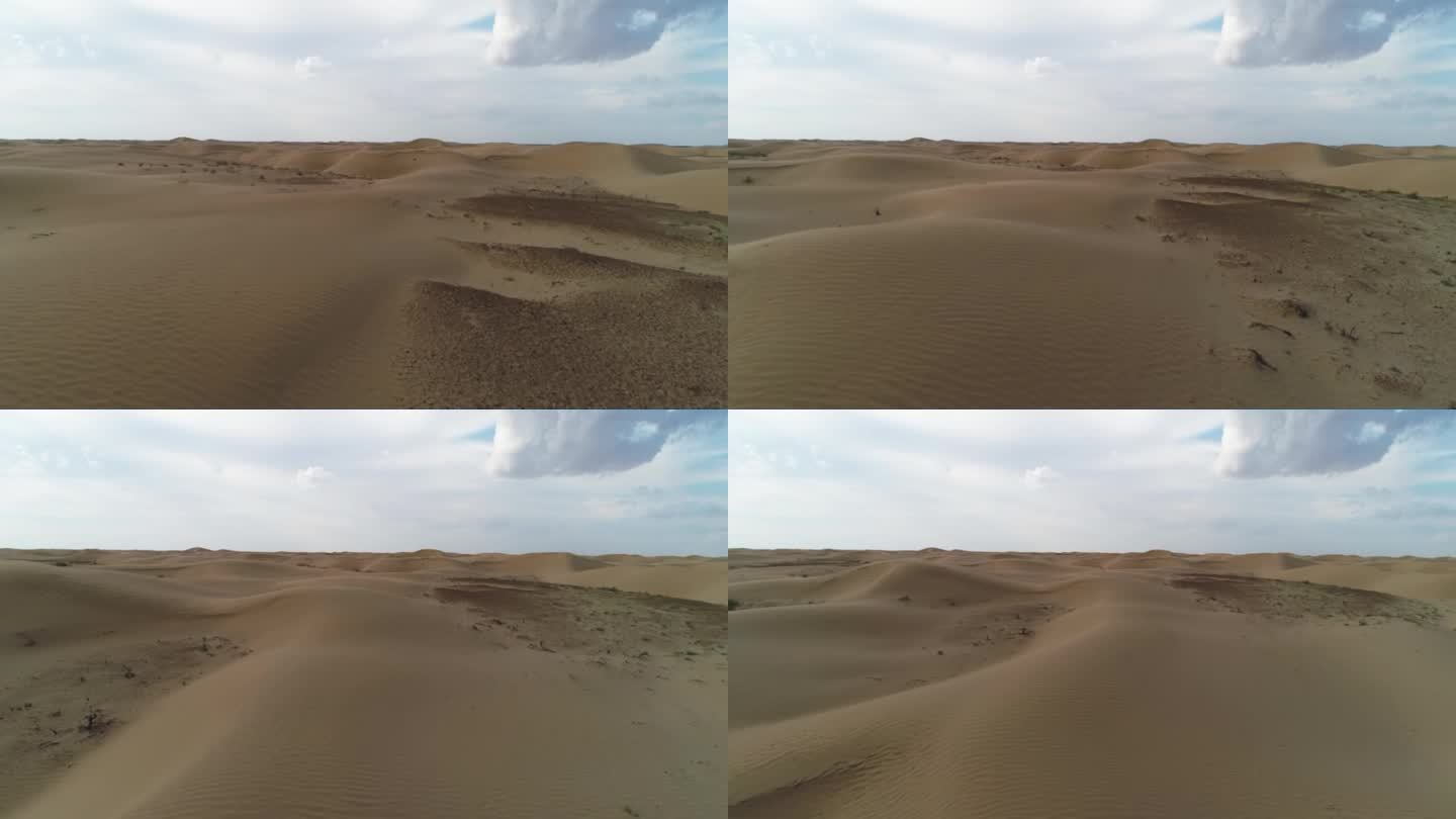 无人机在沙漠沙丘上低空飞行，用螺旋桨扬起尘土