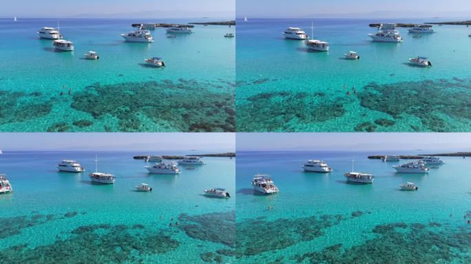 航拍的著名的蓝色泻湖在塞浦路斯岛。清澈碧绿的地中海海水和在塞浦路斯西海岸蓝色泻湖的游艇与游客