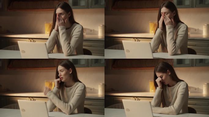 年轻女子在家里用笔记本电脑工作时情绪失控