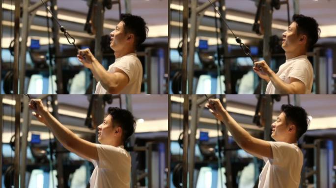 中国年轻帅哥在健身房锻炼健身的超慢镜头