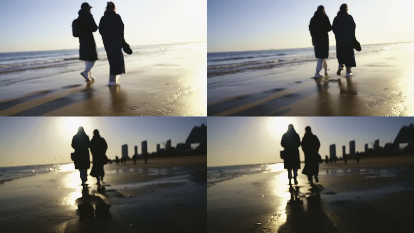 2个女人在海边夕阳下散步