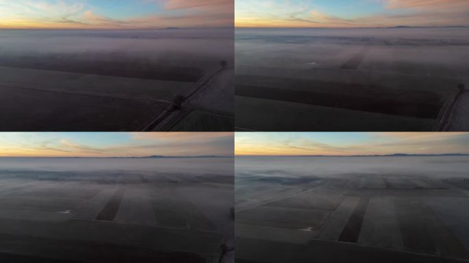 日出时，无人机拍摄的雾气笼罩在农村农田作物上