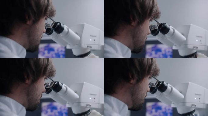 男科学家在显微镜下观察的特写镜头