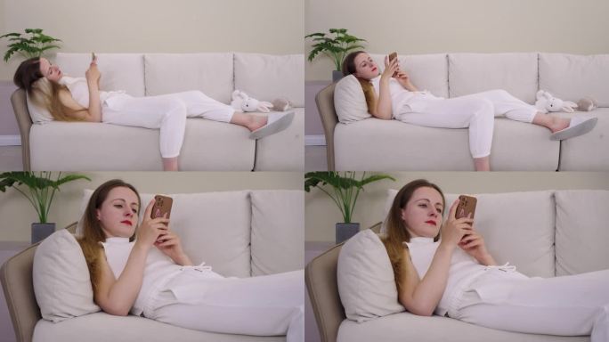 躺着玩手机外国美女躺在沙发上玩手机