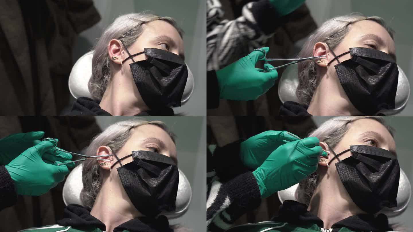 白人女性在右耳上打耳膜穿孔。