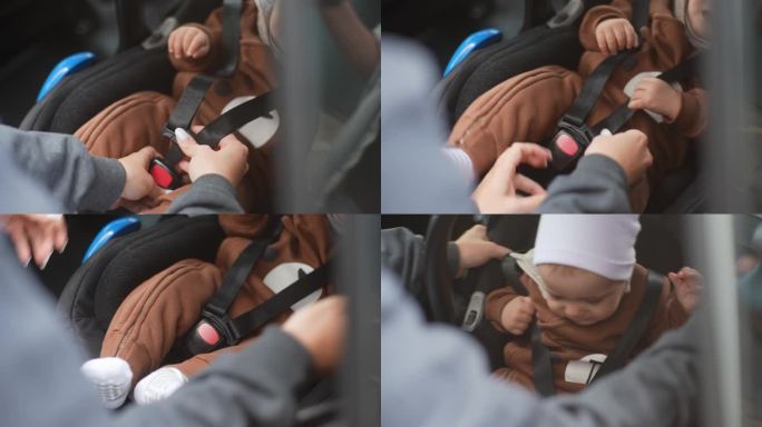 特写镜头中，一位无法辨认的年轻母亲正将安全带系在汽车座椅上的男婴身上。可爱的小孩在车上系上安全带。