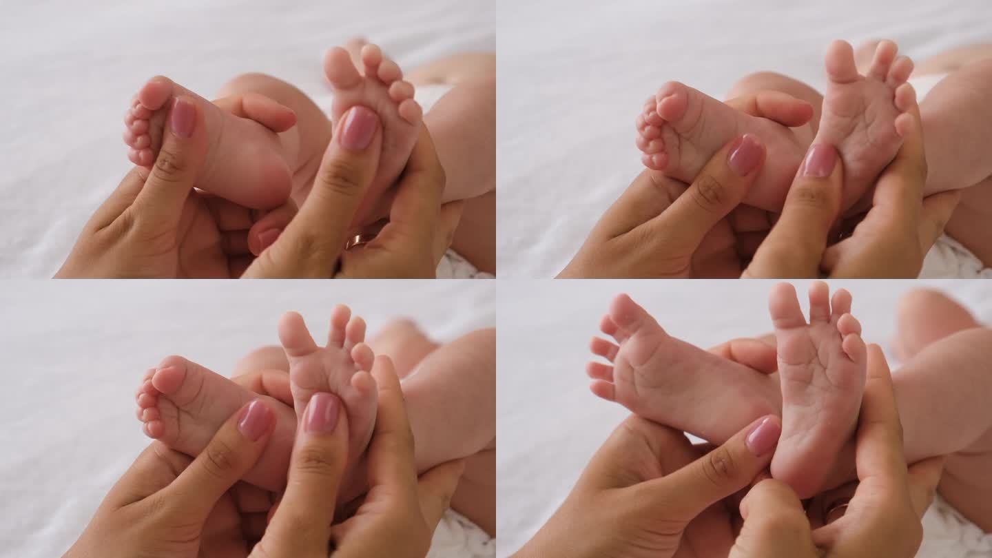 妈妈给婴儿做足部按摩。有选择性的重点。人。