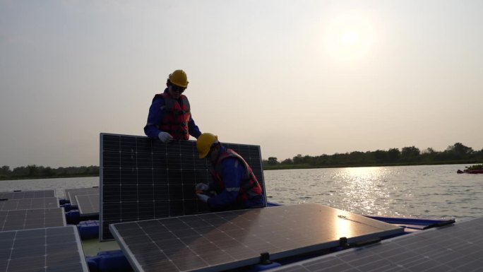 光伏工程师研究浮动光伏。工人检查和修理漂浮在水面上的太阳能电池板设备。工程师在湖面上安装浮动太阳能板