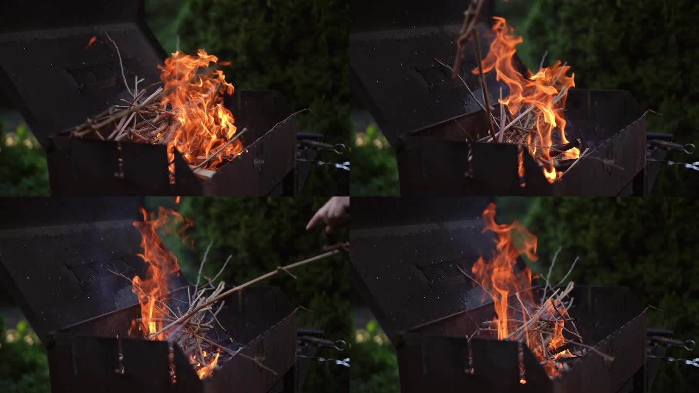 特写镜头。一名男子将灌木和干柴扔到烧烤架上的火上。在烧烤架上燃烧原木产生的火。