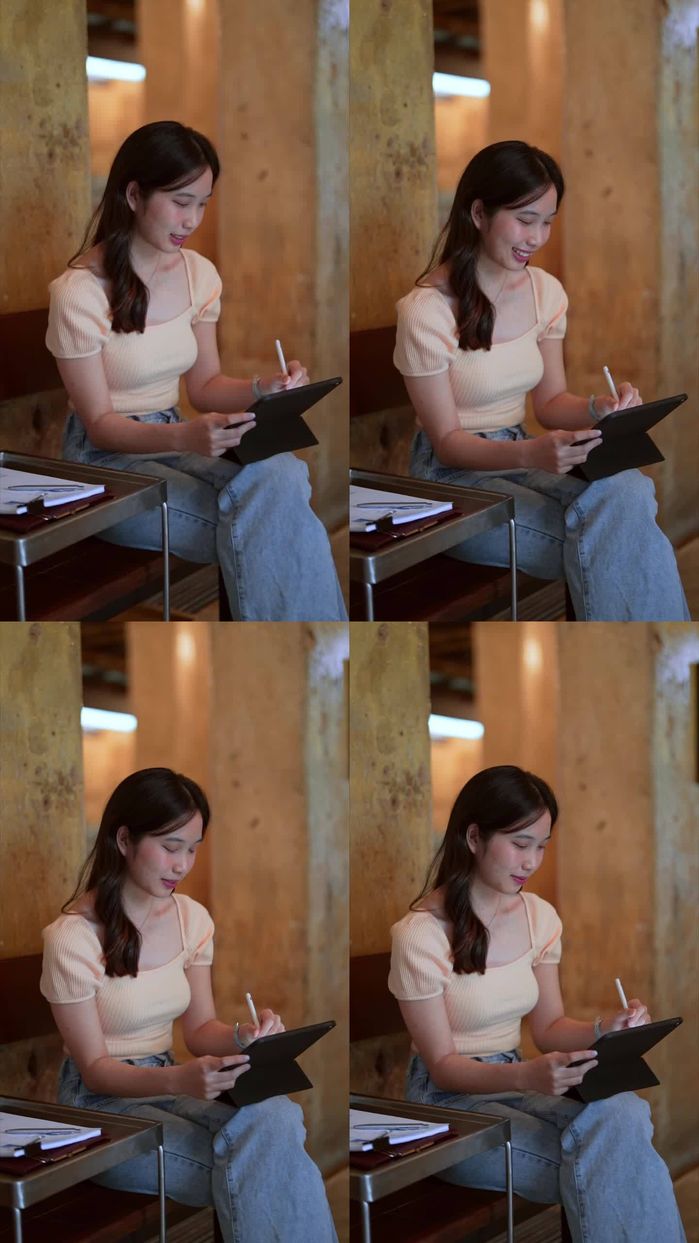 一名亚洲女性在咖啡馆用平板电脑远程工作，营造轻松无压力的氛围。拥抱在办公室外工作的自由