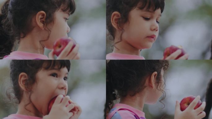 一个女孩在吃红苹果