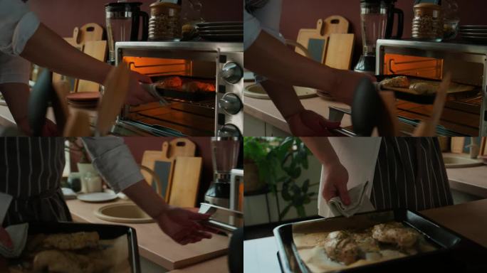 厨师从迷你电烤箱中取出烤鸡胸片