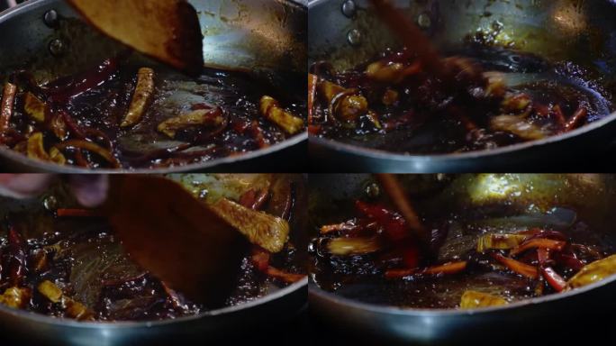厨师在煎蔬菜和肉的锅里加入酱油