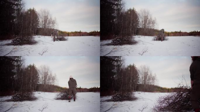 冬天，一个人在农场的雪地上行走，拔下被砍光了叶子的树。广角镜头