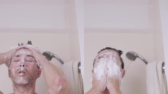 一名男子在淋浴喷头中冲洗头发上的洗发水