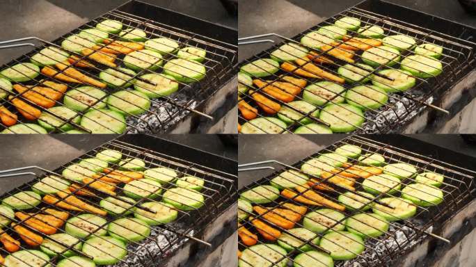 切碎的西葫芦和胡萝卜，用香草和香料在火上烤熟。美味的新鲜蔬菜烧烤烤炉格栅。素食烧烤。户外休闲