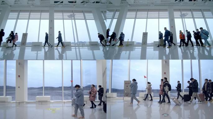 机场大厅一群旅客拖着行李箱行走在航站楼