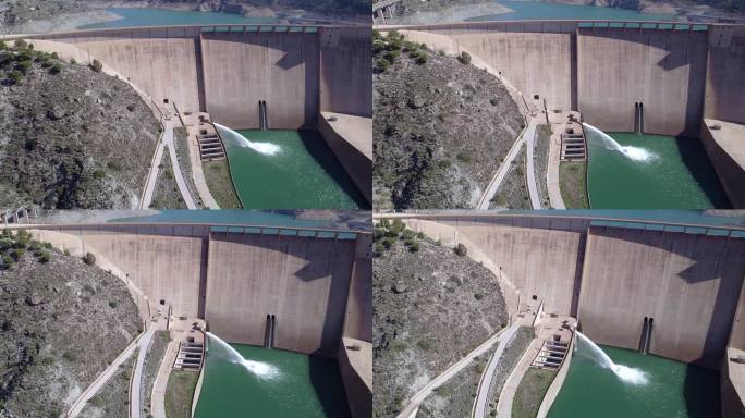 重力坝将水排入河中。豪厄尔饥饿阀工作。大坝和河流的轨道鸟瞰图。可再生能源。水电站。到站