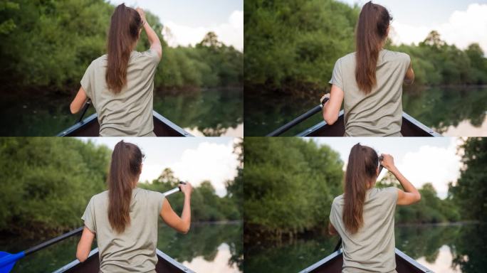 女子在一条令人惊叹的宁静河流上划独木舟