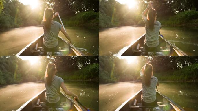日落时分，一名女子划着独木舟探索一条美丽的河流