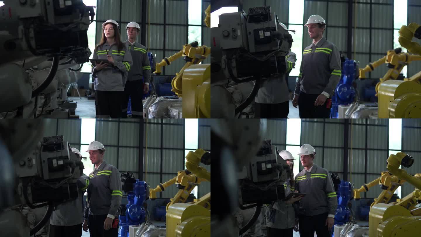 工厂工程师用智能平板电脑检查机器。工人在机器机械臂上工作。工业工厂的远程系统焊机。人工智能概念。