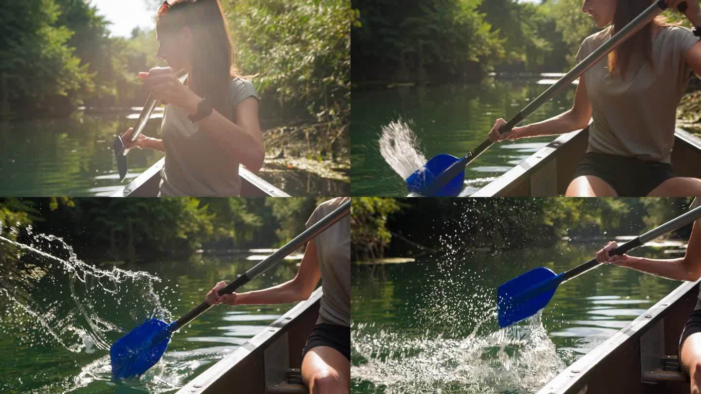 一个女人在河上划着独木舟，溅起水来，玩得很开心