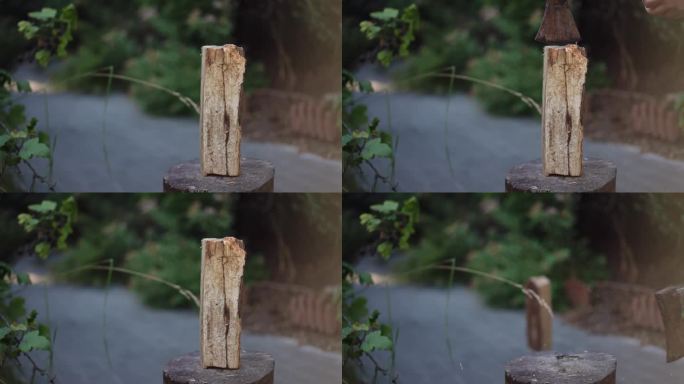 特写镜头。用放在室外圆木上的斧头劈木头。准备柴火。劈柴生火。