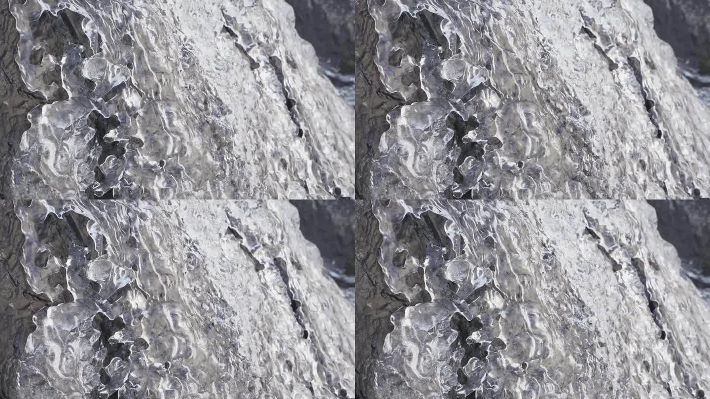 水流过岩石，融化清澈的冰。