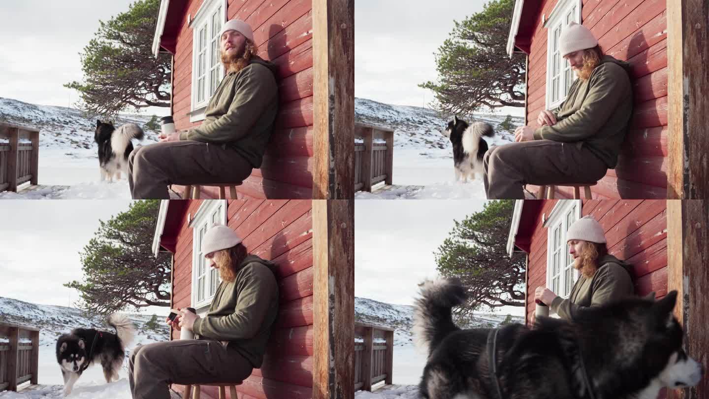 在挪威特隆德拉格郡的贝萨克，一名男子在冬天和他的狗一起品尝热饮——特写