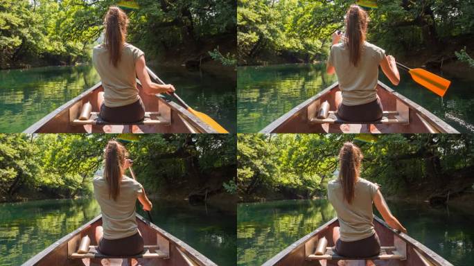 在雄伟的荒野中，一个女人在河上划着独木舟