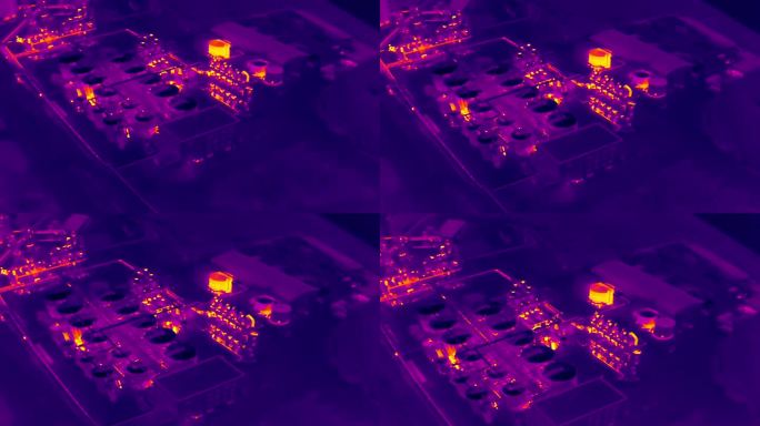 带有工厂和仓库的工业区的航空红外热视图，紫色和黄色色调