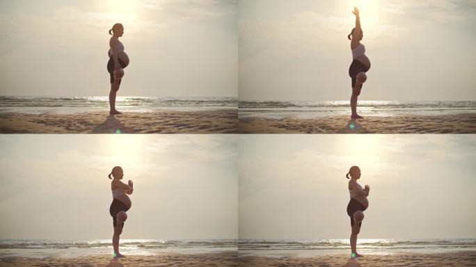 年轻的孕妇在海滩上练习瑜伽